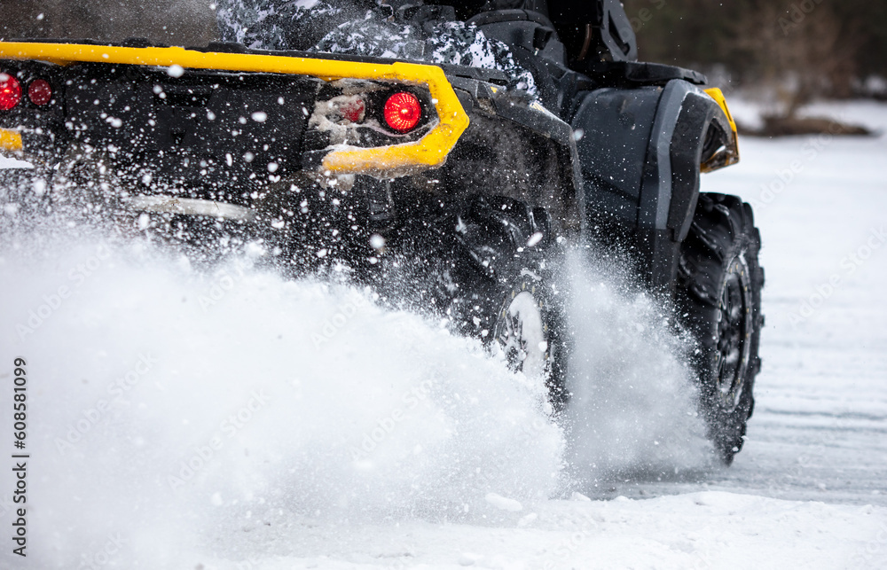 Naklejka premium Quad bike rides on white snow in winter. Sport
