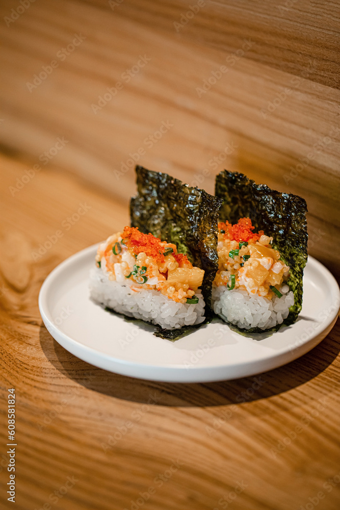 Portion of japanese hand rolls with shrimp and caviar on table Portion of japanese hand rolls with shrimp and caviar on table