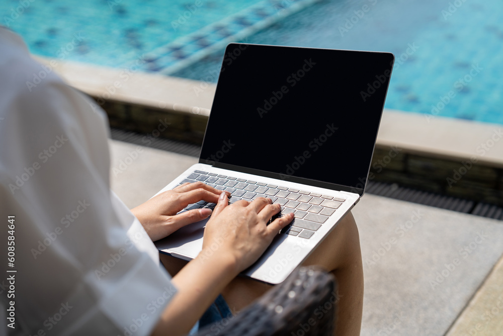 Young asian woman with long black hair is using laptop computer sitting ...