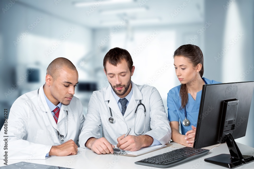Doctors happy young team works with computer Doctors happy young team works with computer
