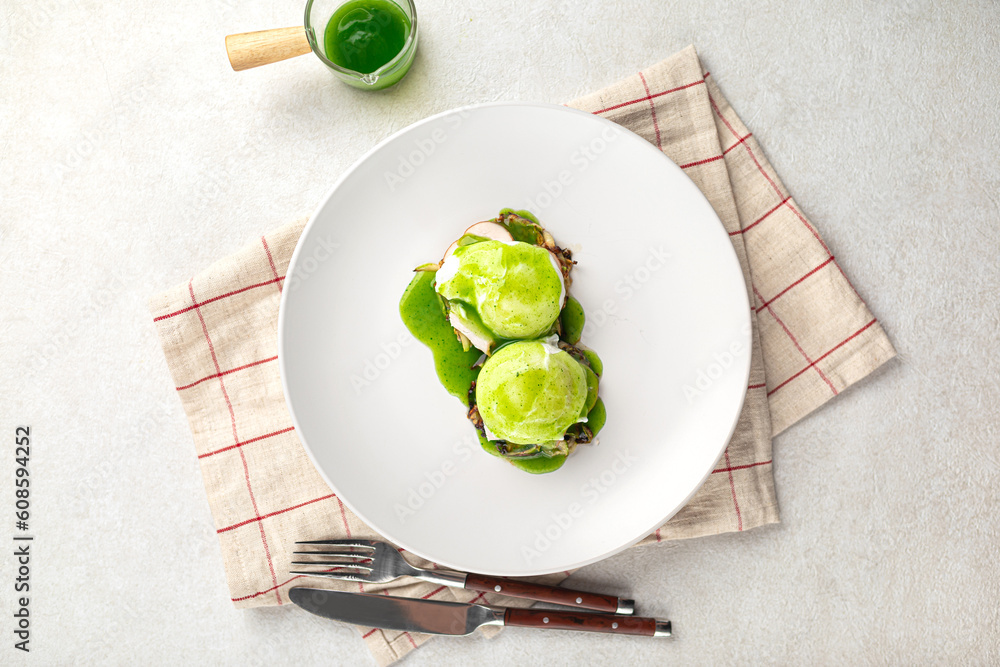 Portion of gourmet breakfast with poached egg and green sauce Portion of gourmet breakfast with poached egg and green sauce