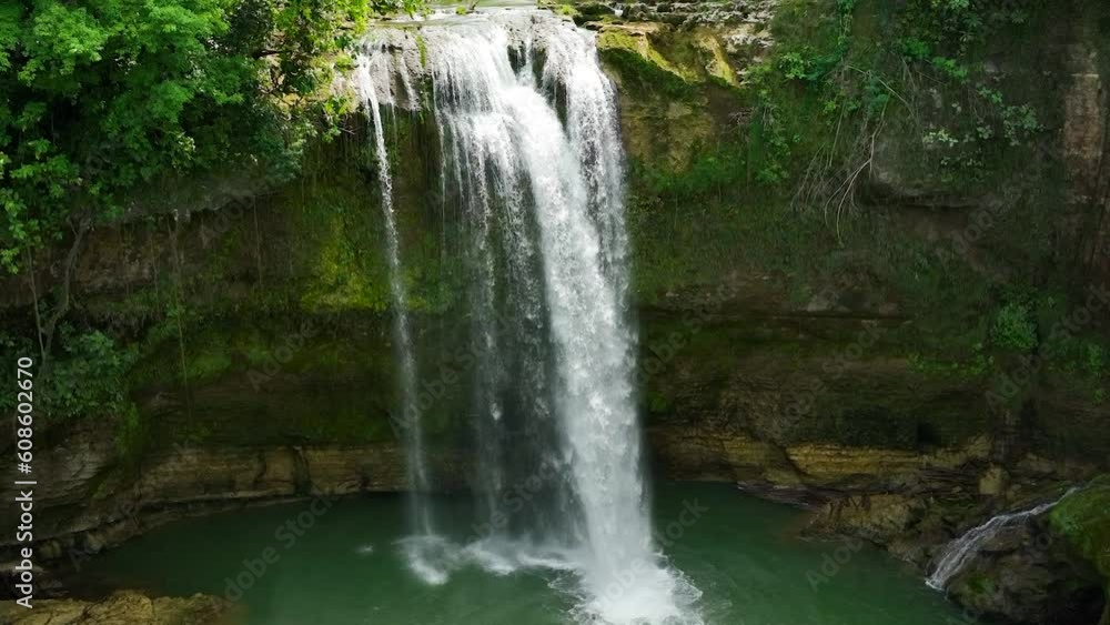 Waterfall in the rainforest in slow motion. Tropical Ben-Ben Falls in mountain jungle. Negros, Philippines. Waterfall in the rainforest in slow motion. Tropical Ben-Ben Falls in mountain jungle. Negros, Philippines.