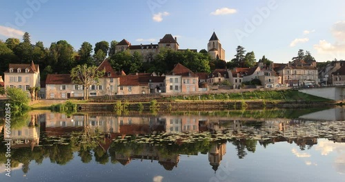 The still waters of the river Creuse reflect the town of Le Blanc in Indre, France.