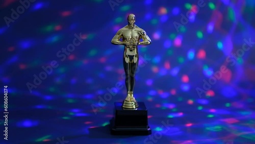 oscar gold statue trophy on a black background, symbol of the victory of the actor in his profession. editorial. Closeup Slow motion.