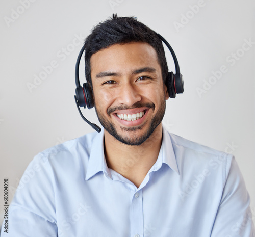 Photography Portrait of man in call center with smile, headset and happy to help at customer service agency or sales desk