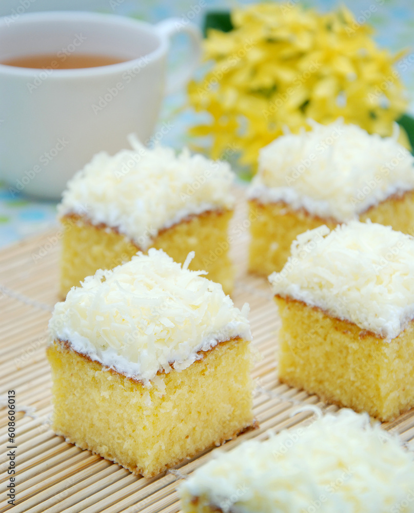 Delicious cake with cream and cheese, and cup of tea as a background Delicious cake with cream and cheese, and cup of tea as a background