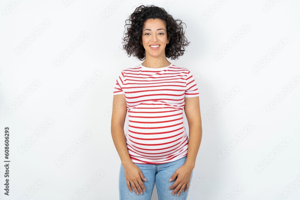 Close up photo of Beautiful pregnant woman wearing striped T-shirt toothy smiling Close up photo of Beautiful pregnant woman wearing striped T-shirt toothy smiling