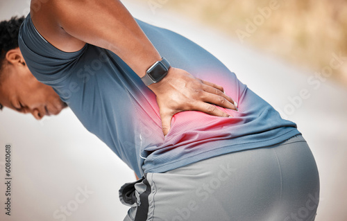 Fitness, back pain and accident with a sports man outdoor in nature for cardio or endurance running. Exercise, medical or anatomy injury with a male athlete holding his body while training for health