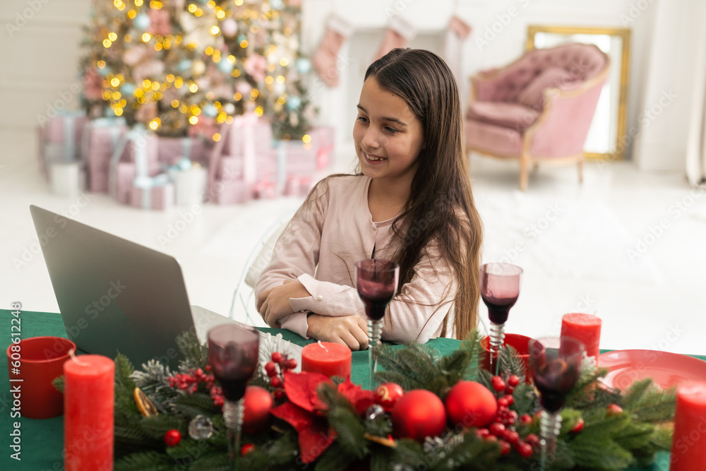 Happy girl using laptop at home during christmas Happy girl using laptop at home during christmas