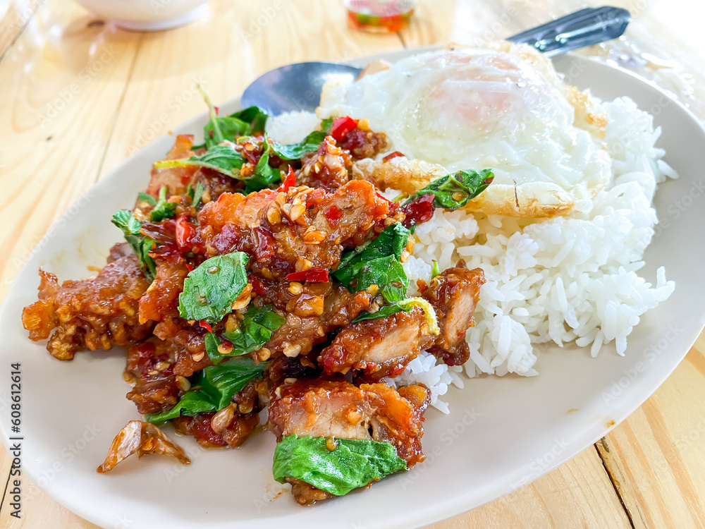 Rice topped with crispy pork belly with Thai basil and fried egg Rice topped with crispy pork belly with Thai basil and fried egg