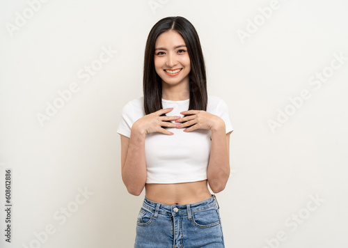 Beautiful smiling happy young asian woman age around 25 in white shirt. Charming female lady standing pose on isolated white background. Asian cute people looking camera confident with backdrop.