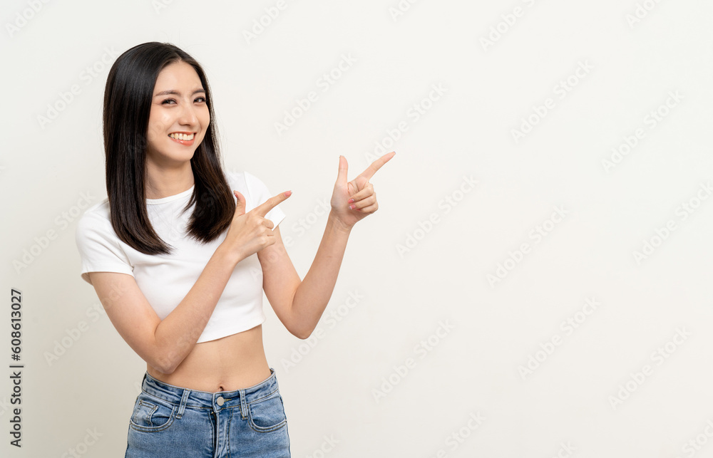 Happy beautiful young asian woman in white shirt pointing finger to copy space. Smiling female lady with blank space. Asian cute Pretty people looking copy space text advertise Happy beautiful young asian woman in white shirt pointing finger to copy space. Smiling female lady with blank space. Asian cute Pretty people looking copy space text advertise