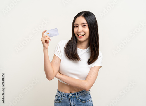 Portrait beautiful asian women standing pose holding credit card to shopping payment. Attractive Happy business woman with credit card financial concept.