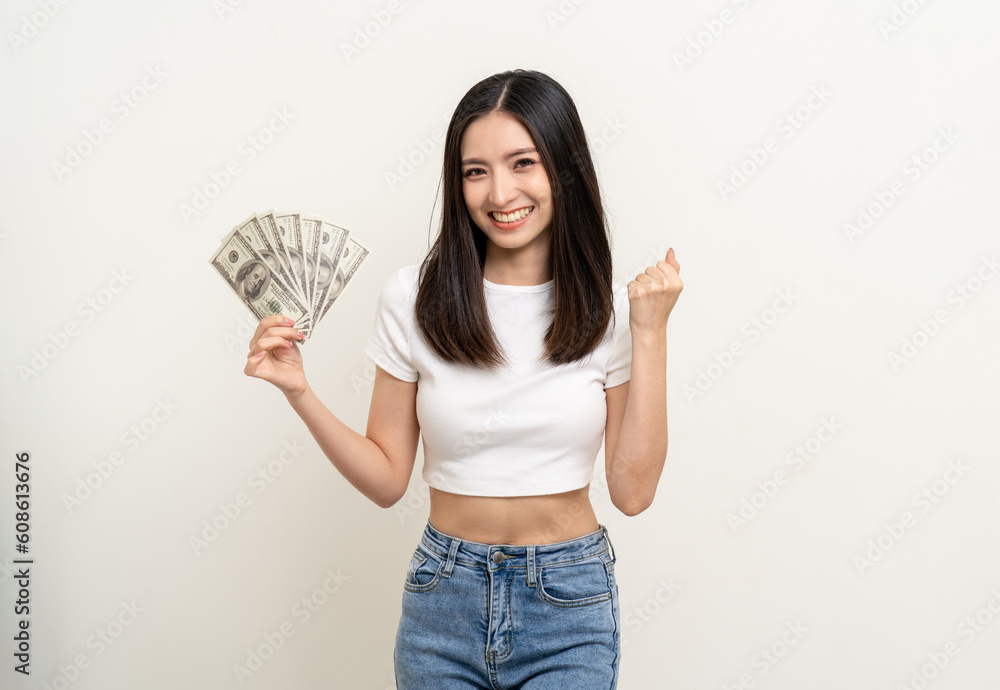 Cheerful young Asian business woman showing lot of money. Attractive female with dollar banknotes. Happy asian woman counting money us dollar Financial business concept on isolated white background Cheerful young Asian business woman showing lot of money. Attractive female with dollar banknotes. Happy asian woman counting money us dollar Financial business concept on isolated white background