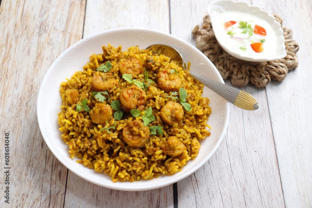 Prawns Biryani or shrimp Pulao. also called jheenga pilaf or jhinga biryani in India. known as Kolambi bhat in Marathi. Garnished with mint leaves, and coriander along with yogurt Raita. Copy space Prawns Biryani or shrimp Pulao. also called jheenga pilaf or jhinga biryani in India. known as Kolambi bhat in Marathi. Garnished with mint leaves, and coriander along with yogurt Raita. Copy space