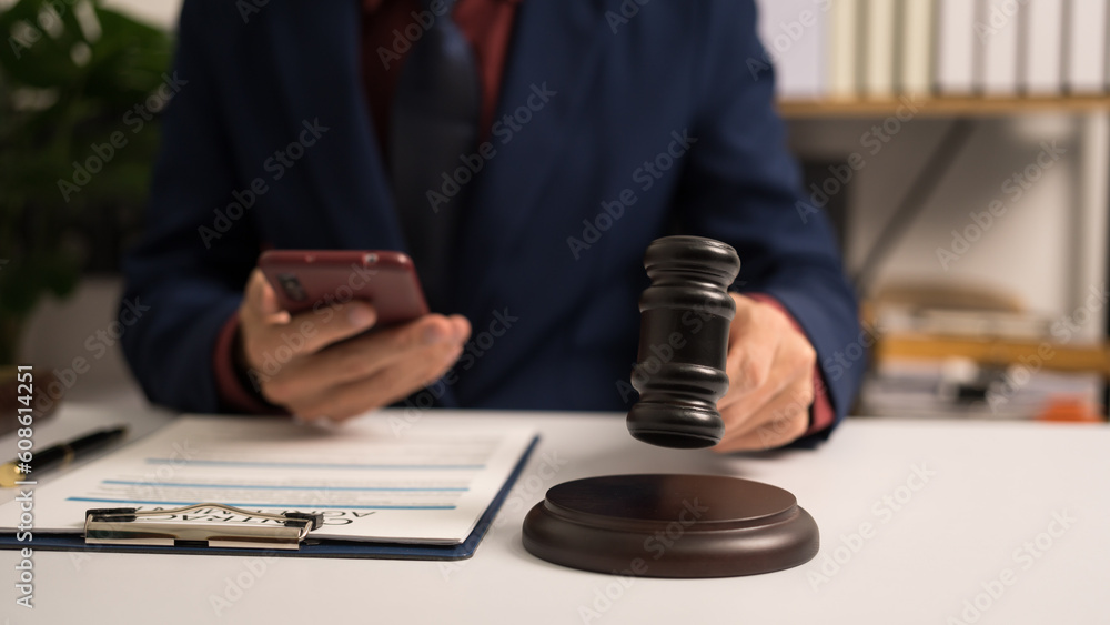 Male lawyer working with law book, A legal binding, Unilateral contract, Multilateral, Non-reciprocal contract, Default, Obligation, Power of attorney, Defense of a prescription, Court decree Male lawyer working with law book, A legal binding, Unilateral contract, Multilateral, Non-reciprocal contract, Default, Obligation, Power of attorney, Defense of a prescription, Court decree