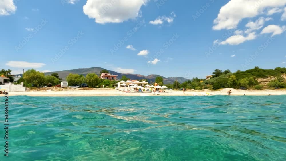 Europe, Greece summer holiday, view from sea level at sand beach. Europe, Greece summer holiday, view from sea level at sand beach.