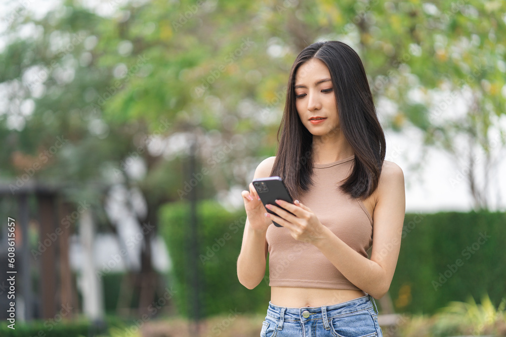 Happy feeling of beautiful Young woman using and text on smartphone. She shopping online. She smile very happy. Teenage girl reading news from mobile cell phone feeling excited.