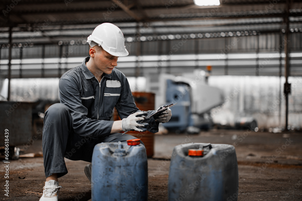 Industrial waste inspector examines the correct storage of hazardous
