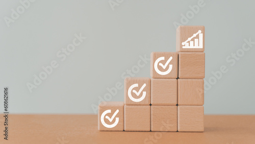 For Corporate regulatory and compliance. Goals achievement and business success. Checklist on wooden cube block and increasing graph on top