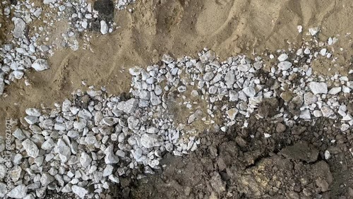 White gravel between sand and ground