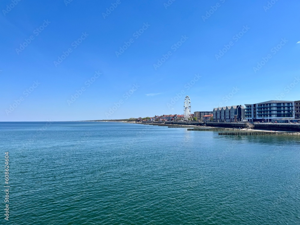 City sea coastline with promenade, blue sea and blue sky 