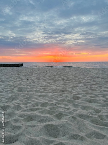 Purple twilights on the sandy beach, cloudy sunset seascape, pastel colors 