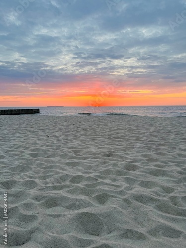 Purple twilights on the sandy beach  cloudy sunset seascape  pastel colors 