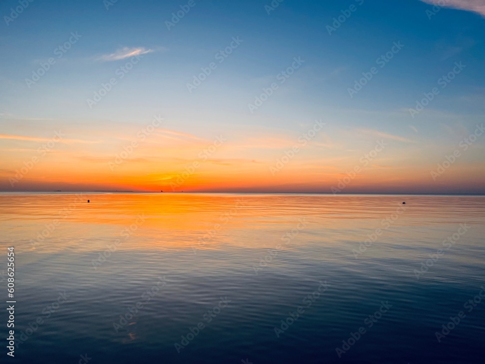 Orange sea sunset, orange sea horizon, clear blue sea, evening romantic sea coastline, no people