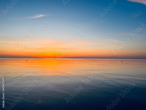 Orange sea sunset, orange sea horizon, clear blue sea, evening romantic sea coastline, no people