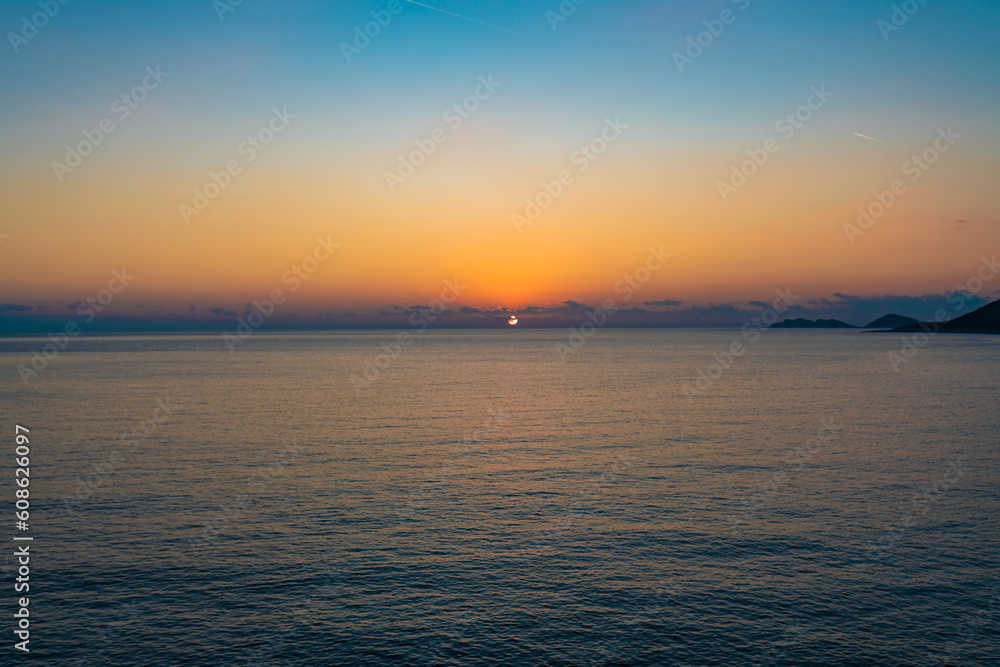 Brightly colored sunset over the calm Mediterranean Sea