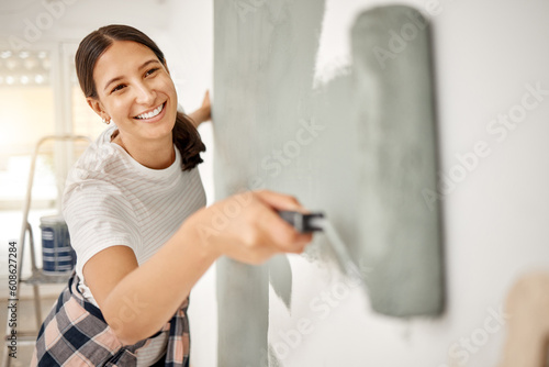 Fototapeta Naklejka Na Ścianę i Meble -  Woman, renovation and painting a home wall in DIY, house project or maintenance or construction, interior design and decoration. Paint, bedroom or remodel space with paintbrush, roller and painter