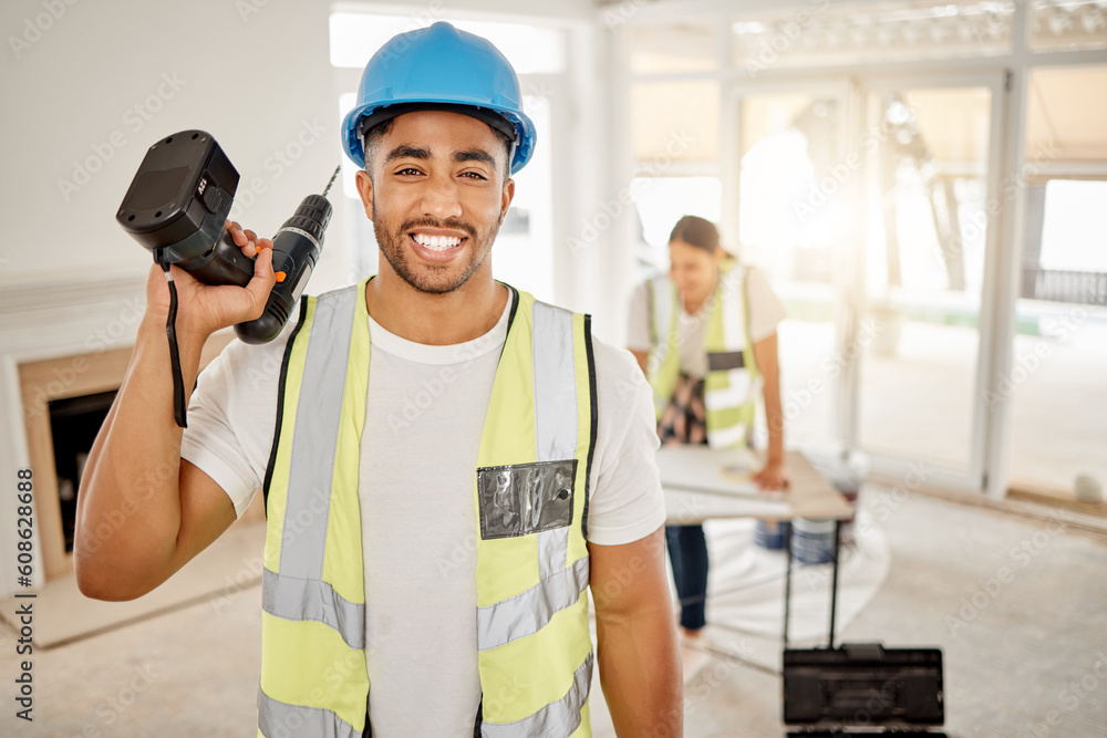 Portrait of man, construction and home renovation with drill, helmet and working mindset in apartment. Yes, smile and diy renovations, happy handyman in safety and building project tools in new house Portrait of man, construction and home renovation with drill, helmet and working mindset in apartment. Yes, smile and diy renovations, happy handyman in safety and building project tools in new house