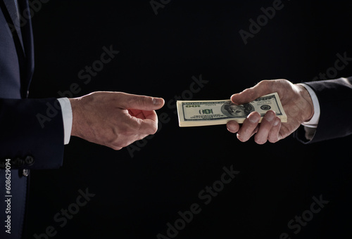 Money transfer between colleagues on a black background