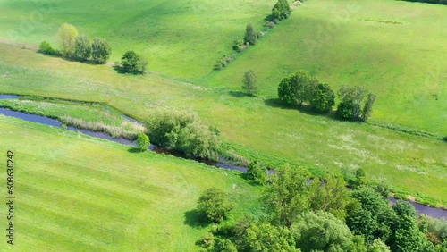 Aerial view of denauturated straightened small river Ise flowing through intensively farmed land near Gifhorn, Germany. photo