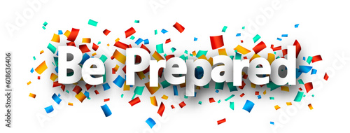 Be prepared sign over colorful cut out ribbon confetti background.
