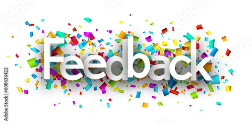Feedback sign over colorful cut out ribbon confetti background.