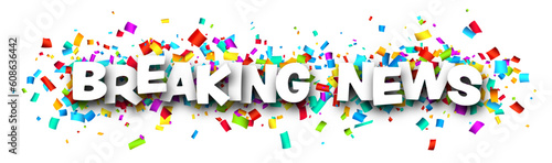 Breaking news sign over colorful cut ribbon confetti background.
