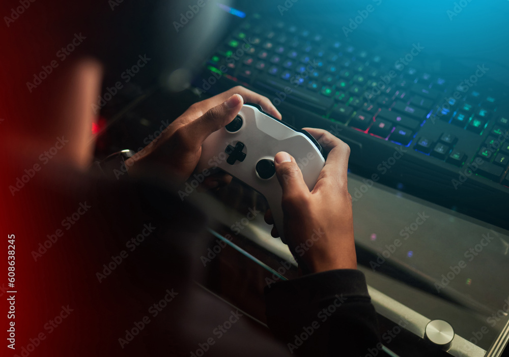 Gaming controller in hands, playing games and online streaming with gamer  competition and esports. Video game tech, streamer person in dark room and  play tournament with joystick and keyboard Stock Photo