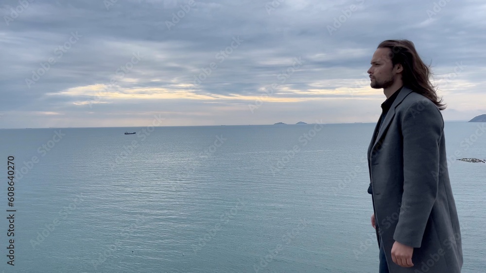 man stands near the sea
