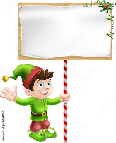 A Christmas elf or pixie or Santa's helper holding a large Christmas sign in traditional elf clothes