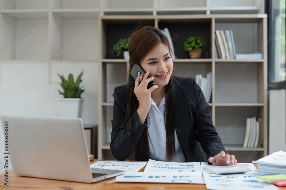 Successful businesswoman with an working from an office telemarketing and taking orders over the phone or consulting with clients Successful businesswoman with an working from an office telemarketing and taking orders over the phone or consulting with clients