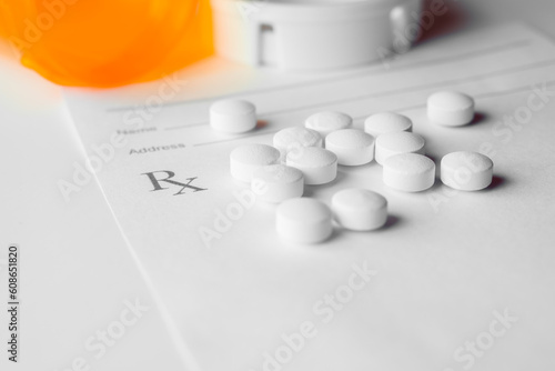 white prescription pills laying on rx pad on white background photo