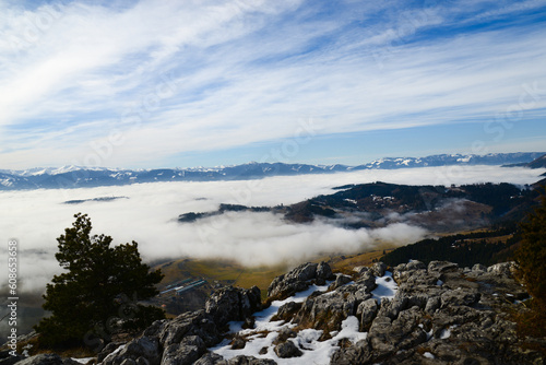 View from Cerenova skala (rock) in West Tatras in Liptov. Near Liptovsky Mikulas city in foggy weather. Spring time, cloudy weather, Slovakia. Green forest. Village in the fog.