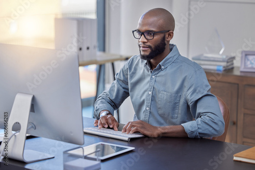 Programmer, computer and black man typing for software, coding or email in office. IT, desktop and African professional working on cyber security, business code or internet research for programming.