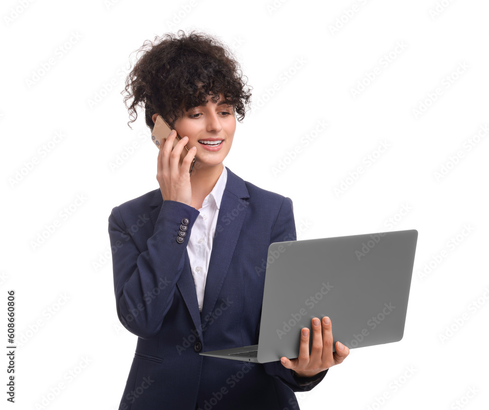 Beautiful businesswoman in suit with laptop talking on smartphone against white background Beautiful businesswoman in suit with laptop talking on smartphone against white background