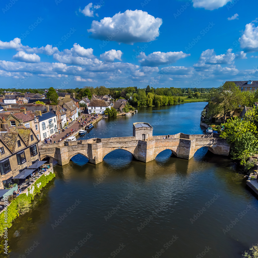 An aerial view along the River Great Ouse towards footbridge in the town of St Ives, Cambridgeshire in summertime