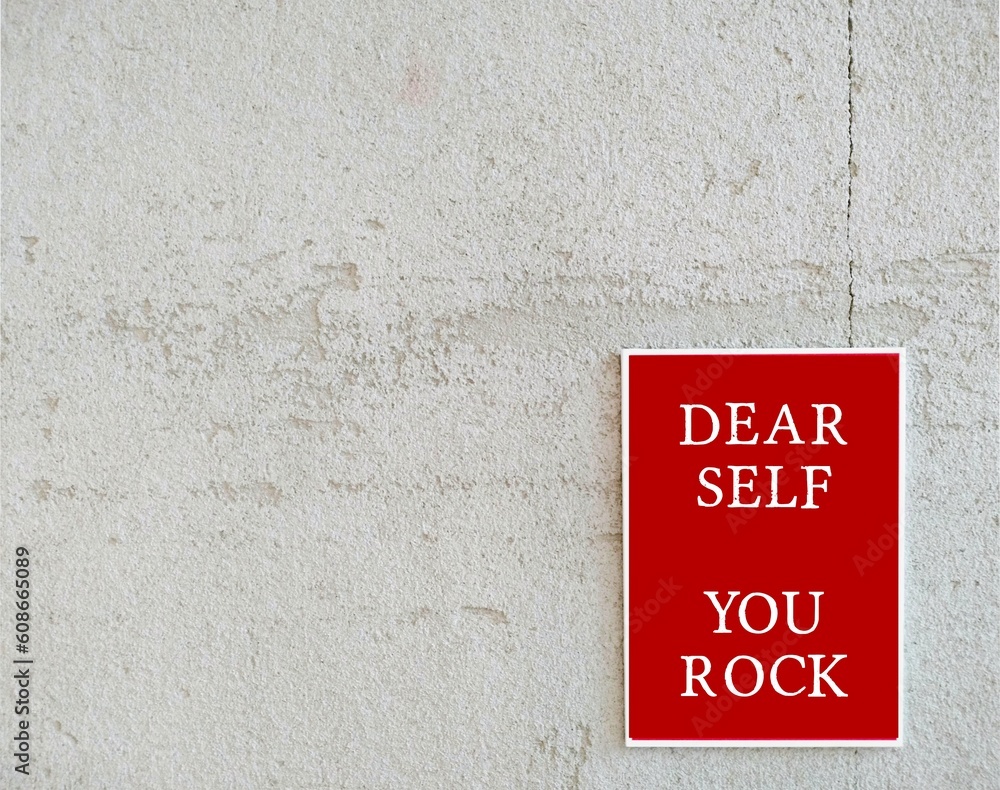 Self Estime Rocks Red poster on copy space white wall with message DEAR SELF YOU ROCK ...
