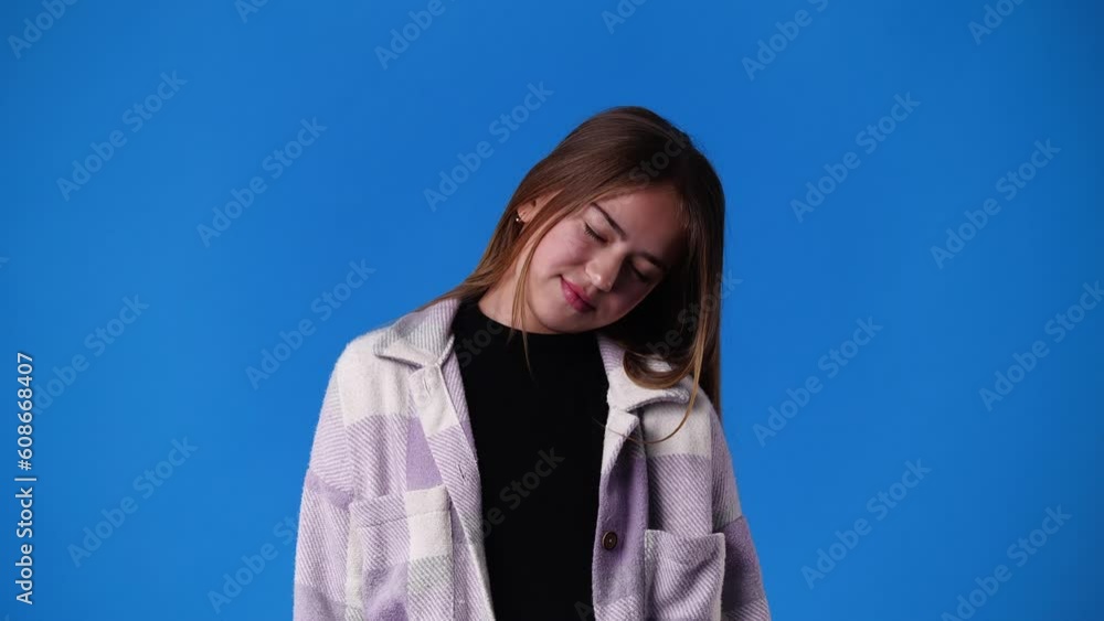 4k video of cute girl smiling over blue background. 4k video of cute girl smiling over blue background.