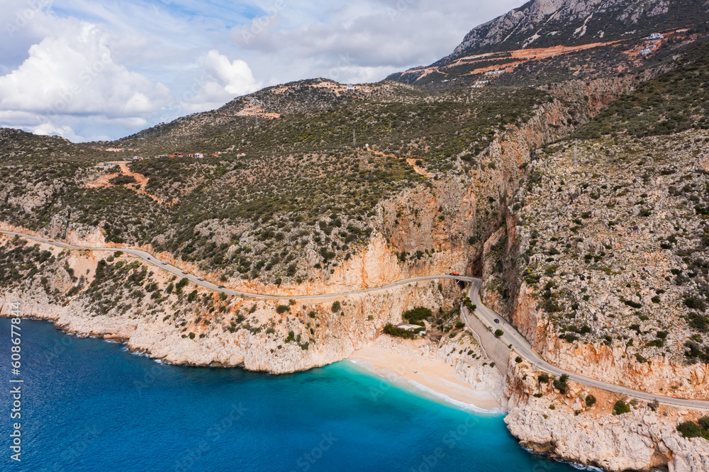 Aerial view of a beautiful bay with a beach and turquoise sea among big mountains. Kaputas beach, Kas, Türkiye. Aerial view of a beautiful bay with a beach and turquoise sea among big mountains. Kaputas beach, Kas, Türkiye.